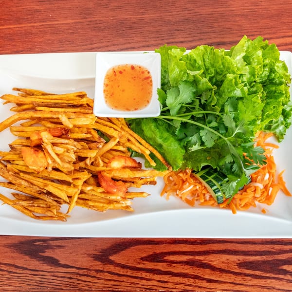 Vietnamese shrimp and sweet potato fritters with lettuce, herbs, pickled carrots, and dipping sauce.
